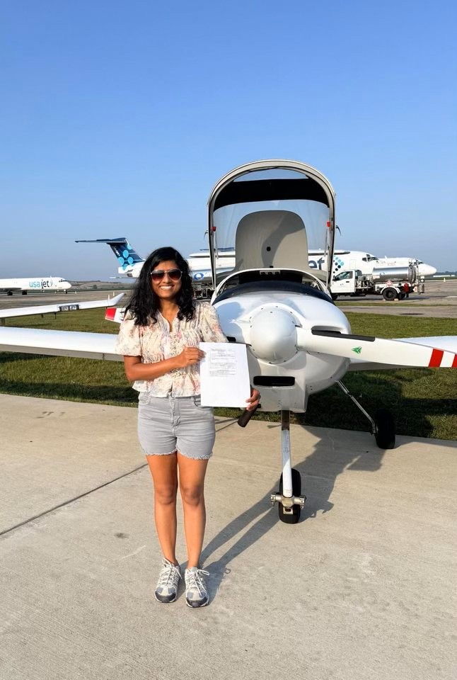 Sigma posing in front of an airplane